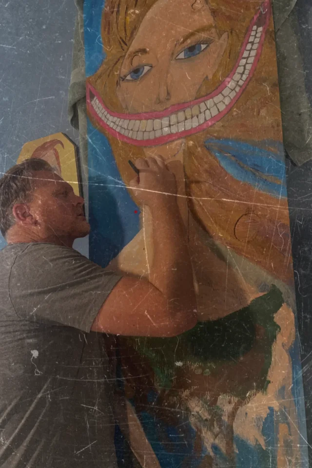 J. Mike Oliver painting a large canvas, brush in hand